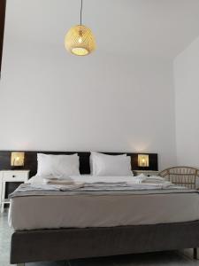 a bedroom with a large bed with a white wall at M & N Residence in Panormos Rethymno +15 photos