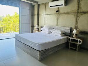a bedroom with a large bed with white sheets and pillows at Nuraai River Chalets in Ambalangoda +58 photos