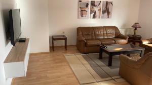 a living room with a couch and a television at BT Lux apartment 2 in Skopje