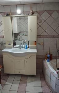 a bathroom with a sink and a tub at Maridina cottage Corfu Village in Kastellánoi