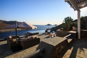 a patio with couches and a view of the ocean at MV Kythnos in Agios Dimitrios