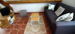 an overhead view of a living room with a couch at Les Pins, plage à pied in Fouesnant