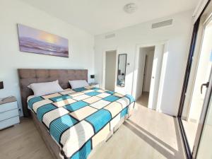 a bedroom with a bed in a white room at Casa Spruit in Rojales +12 photos