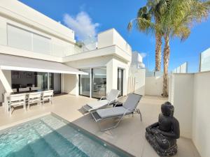 a villa with a swimming pool and a house at Casa Spruit in Rojales