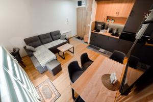 a living room with a couch and a table at Gorski Elegance 1 in Zlatibor