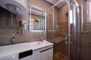 a bathroom with a shower and a sink and a mirror at Gorski Elegance 1 in Zlatibor +66 photos