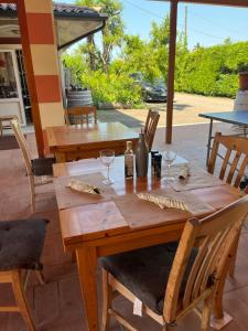 a wooden table with wine glasses on a patio at Agriturismo Al Dugale in Lazise