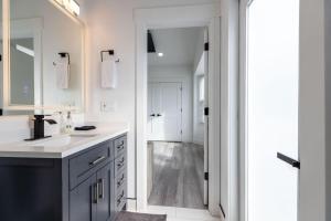a white bathroom with a sink and a mirror at Cottonwood Basecamp-Game Room,6TVS Near Canyons in Sandy +39 photos