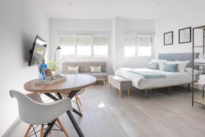 a bedroom with a bed and a table and chairs at El Merendero in Utrera +46 photos