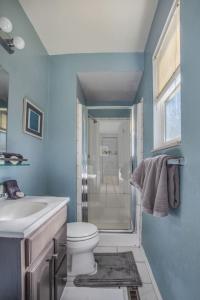 a blue bathroom with a toilet and a sink at 5 bedroom, 3 bath - Sleeps 12, Great for Families in Boulder