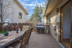 a deck with a table and a grill on a house at 5 bedroom, 3 bath - Sleeps 12, Great for Families in Boulder