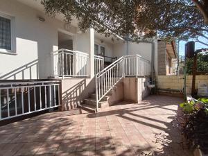 a house with white rails and stairs on it at Apartmani JT Zadar in Zadar