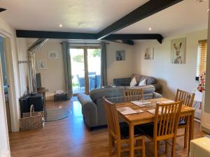 a living room with a couch and a table at The Horseshoe Cottage in Alkham