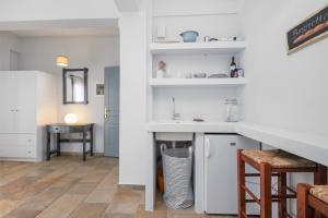 a kitchen with white cabinets and a counter with a sink at Casa del Sol in Kouniádhoi +43 photos