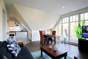 a living room with a couch and a table at Villa Seepferdchen Wohnung 10 in Kühlungsborn