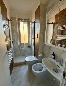 a bathroom with a toilet and a sink and a shower at Casa ViVa Cernusco - Bilocale in Cernusco sul Naviglio