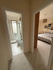 a bedroom with a bed and a bathroom with a toilet at Casa ViVa Cernusco - Bilocale in Cernusco sul Naviglio