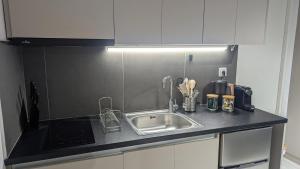 a kitchen with a sink and a counter top at Central Patras Intimate Escape in Patra