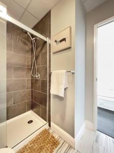 a bathroom with a shower with a glass door at Yale Modern Downtown Chateau in New Haven +22 photos