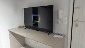 a flat screen tv sitting on top of a table at Central Patras Intimate Escape in Patra