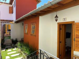 a house with a porch and a door at Chalés do Alferes in Tiradentes