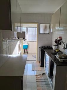 a kitchen with a sink and a counter top at Apartamento Praia Guarujá in Guarujá +10 photos