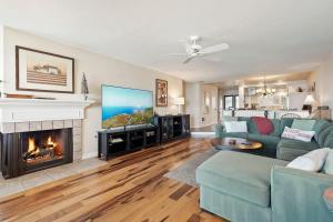 a living room with a couch and a fireplace at SurfSong Dream - Beachfront in Solana Beach