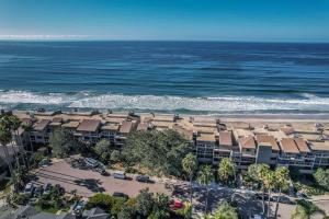 an aerial view of a beach with condos and the ocean at SurfSong Dream - Beachfront in Solana Beach +30 photos