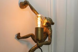 a bronze monkey holding a light on a wall at WEINQUARTIER Lindenring 45 qm 2 SZ Altstadt Küche Kaffee in Naumburg