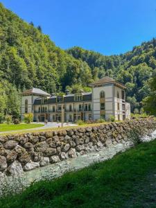 a large building behind a stone wall at Studio Le Flocon à Saint-Gervais-les-Bains in Saint-Gervais-les-Bains