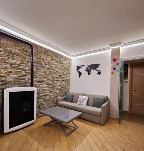 a living room with a couch and a tv at Oasi di Greta Suite Home - Fiumicino in Fiumicino