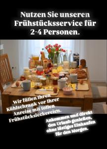 una tavola piena di prodotti per la colazione e un volantino di Ferienwohnung Welle OG a Fehmarn