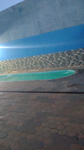 a painting of a green island in the water at Clube com Piscina in Andradina