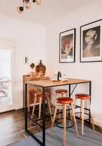 a dining room with a table and four stools at Harvieston in Elie