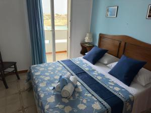 a bedroom with a bed with a stuffed animal on it at Hotel Giglio in Lampedusa