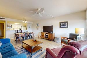 a living room with a couch and a dining room at Oceans 11th in Port Aransas