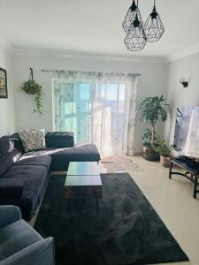 a living room with a couch and a coffee table at Armaçao de Pera - T1 Proche Mer et commodités in Armação de Pêra