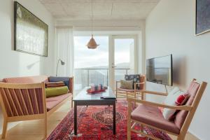 a living room with a table and chairs and a window at 1 BR Apartment - Tórshavn - Parking in Tórshavn