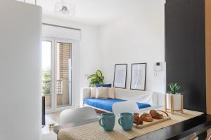 a living room with a bed and a table with bread at Emerald Wave - House on the beach with pool in Torre Grande +20 photos
