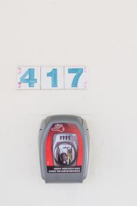 a digital clock on a wall next to a thermometer at Gap Caraïbes in Le Diamant