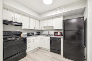 a kitchen with black appliances and white cabinets at Brentwood U5 I Cozy & Comfy I 2bd I Free Parking in Nashville