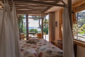 a bedroom with a bed with a view of the ocean at Luxueuse villa bord de mer in La Seyne-sur-Mer +66 photos