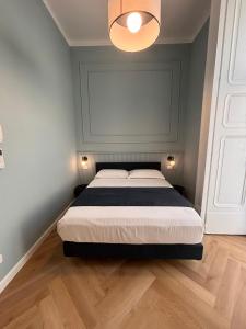 a bedroom with a bed with a blue wall at Boutique Luxury Suite in Naples +99 photos