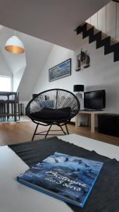 a living room with a chair and a table at **La Bretonnerie, bel appartement de standing in Concarneau