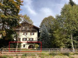 an old house with a red box in front of it at Chesa Madrisa#13 in Klosters