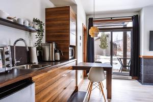 a kitchen with a wooden counter and a table at Lakefront Studio with Resort Mountain View in Lac-Superieur