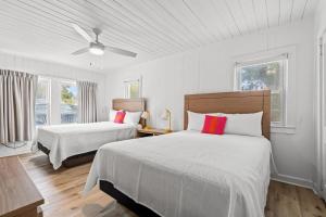 默特尔比奇4BR2BA Sleeps 12 Pet-Friendly Steps to Beach的白色客房的两张床,设有两扇窗户