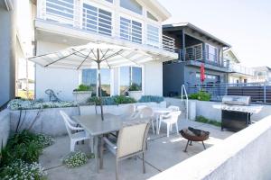 a patio with a table and chairs and an umbrella at 1730 Laguna Drive in Oceano