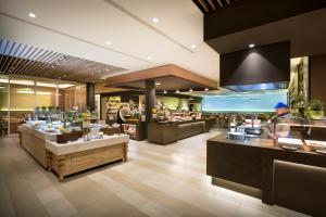 a restaurant with tables and counters in a store at Aminess Vival Maestral Hotel in Novigrad Istria