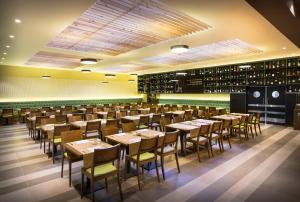 a dining room with tables and chairs and wine racks at Aminess Vival Maestral Hotel in Novigrad Istria